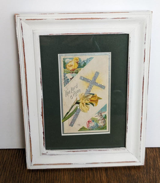 The Lord Has Risen says this vintage greeting card with a cross and yellow flowers in the center. In the upper left is a little fluffy chick and in the bottom right is a bunny.