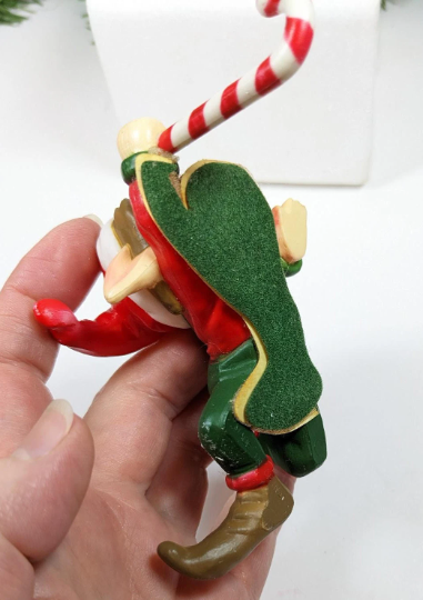 House of Lloyd Elf holding a Candy Cane Stocking Holders