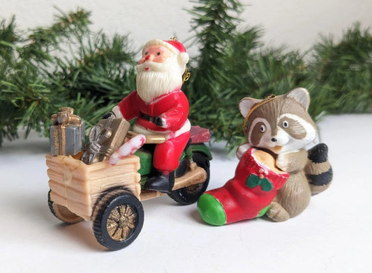 Santa Claus Riding Scooter and Racoon Holding a Stocking Christmas Ornaments