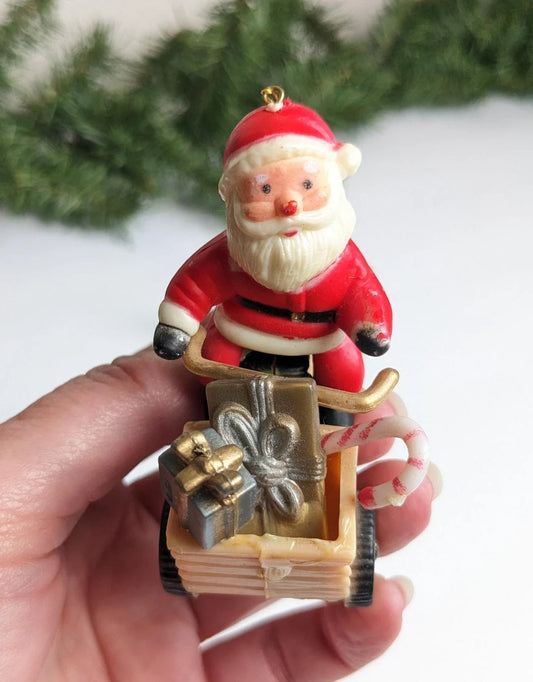Santa Claus Riding Scooter and Racoon Holding a Stocking Christmas Ornaments