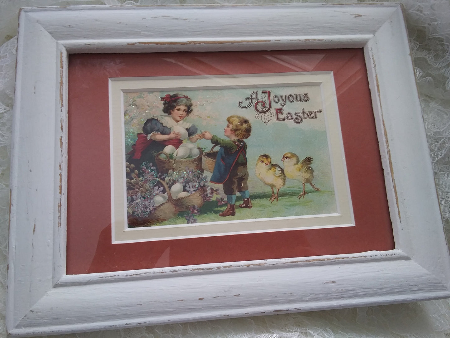 A woman with a basket of ostrich sized eggs interacting witth a small child while to knee high baby chicks frolic nearby. The fantastical sizes of the subjects really add to that early 1900's appeal. 