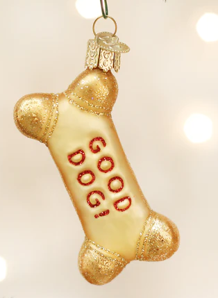 Blown glass ornament in shape of a bone-shaped dog treat. Gold color with red lettering reading "Good Dog!"