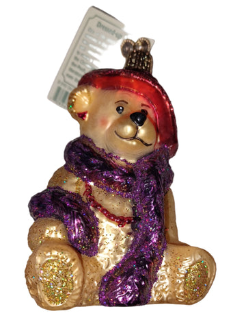 This glass blown ornament of a teddy bear dressed up with red hat, purple scarf, and red beads and earrings is a wonderful gift or stocking stuffer for any child that likes to play dress up.