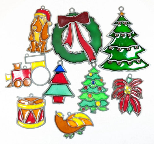 Beautiful collection of faux stained glass ornaments including a hound dog, Xmas wreath, three different syles of Christmas trees, train engine, Drum and sticks, partridge, and pointsetta.