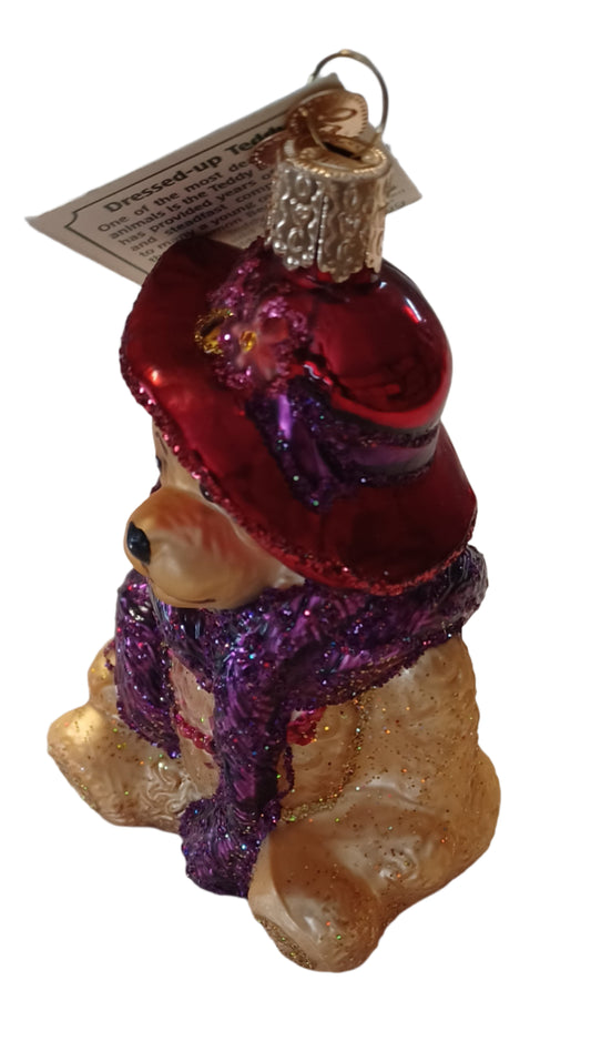Look at this cute red hat with purple accents on this tree ornament. Hand painted and a touch of glitter make this blown glass ornament an attractive gift for a young child or new baby.