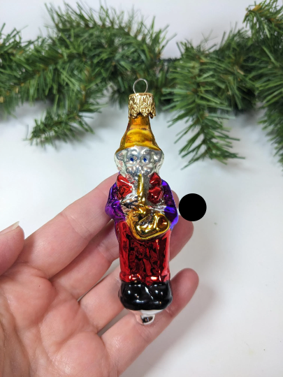 This Blown Glass Ornament, made by Inge-Glas in West Germany, is mouth blown and hand painted.  This pipe smoking Grandpa measures just under 4" tall. 