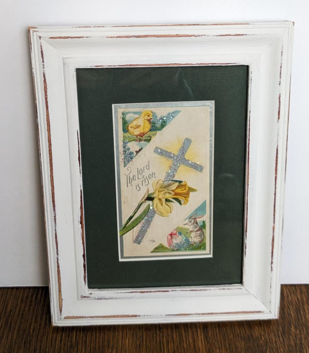 The Lord Has Risen says this vintage greeting card with a cross and yellow flowers in the center. In the upper left is a little fluffy chick and in the bottom right is a bunny. 