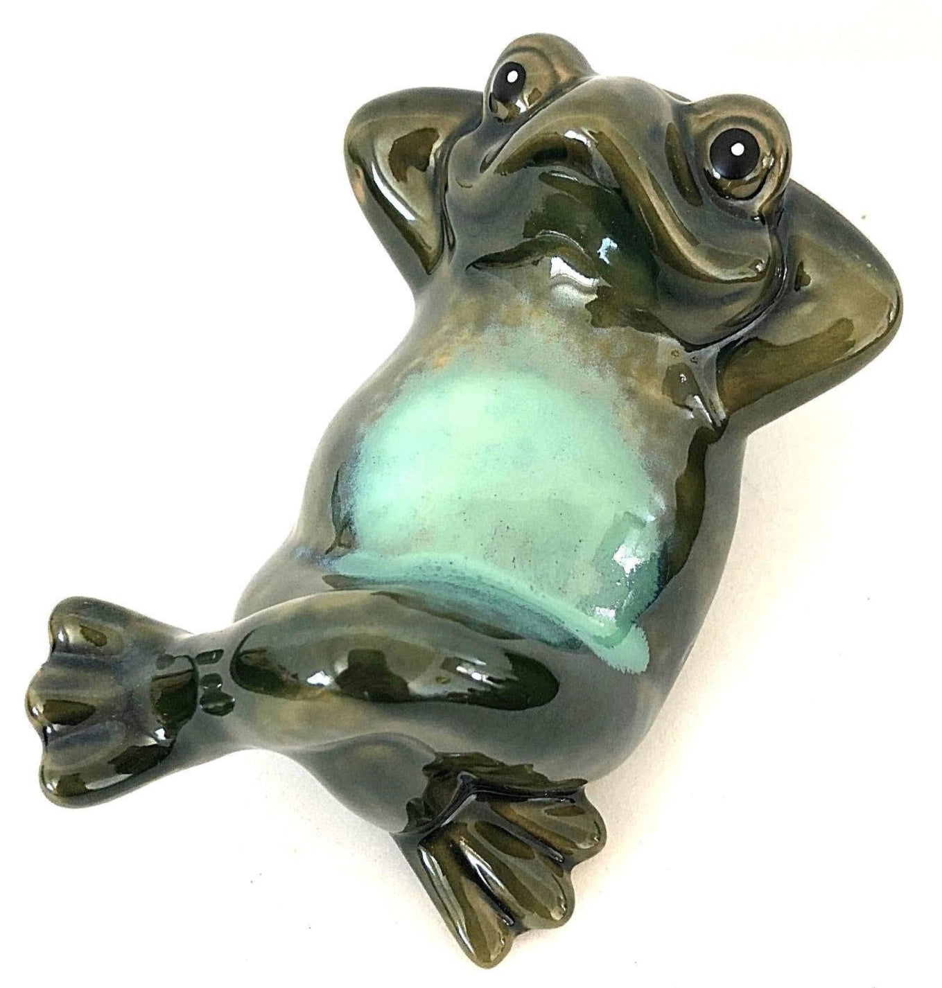 This glazed ceramic frog knows like he knows how to live. Is he looking for animal shapes in the clouds? Or pondering how to lay out the garden this spring?